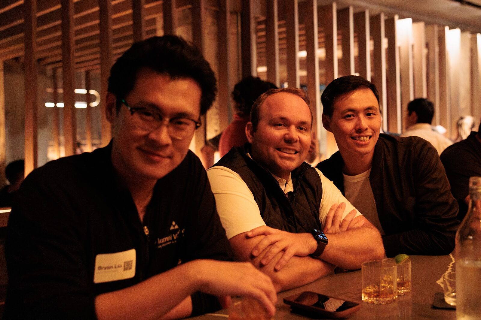 Guests laughing together at the bar